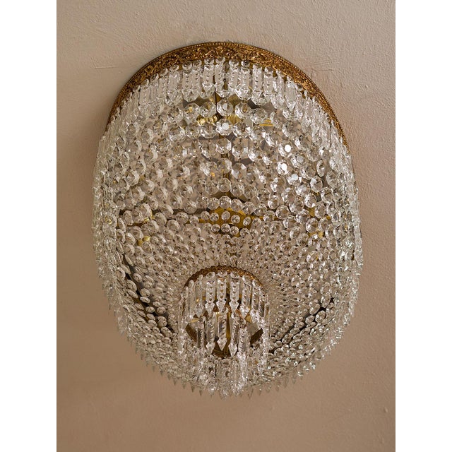 A large oval Empire-style ceiling light, made in Italy around the 1940s and featuring eight lights. The large and elegant...