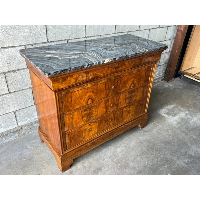 Elegant Louis Philippe French commode dating to the mid-19th century, crafted in richly figured European walnut with four...