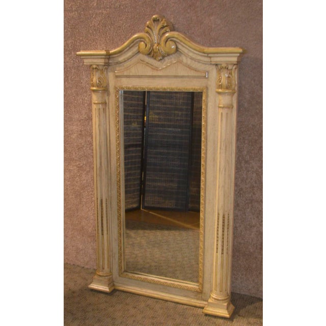 Wall Mirror has an Italian Style with column detail. The frame color is Vintaged Vintage White. The frame material is wood...