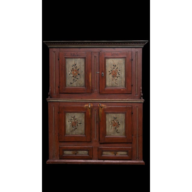 This is a antique Scandinavian cupboard made in 1831 from pine wood. This cupboard has a step-back design where the upper...