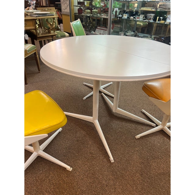 White Mid Centiry table and set of 3 Daystrom chairs in three different colors. One chair has a crack in it, please see...