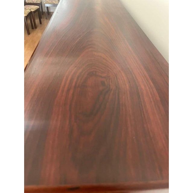 Elegant Danish modern sideboard designed by Arne Vodder, crafted in richly figured rosewood and accompanied by its...