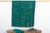 A rare regional variation of West African indigo, featuring saturated teal-green hues and hand-stitched details. This...
