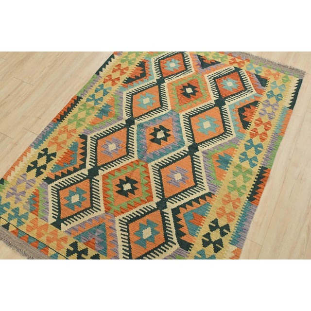 This tribal geometric Kilim rug is handwoven with all wool on a wool foundation. This rug is new and in excellent...