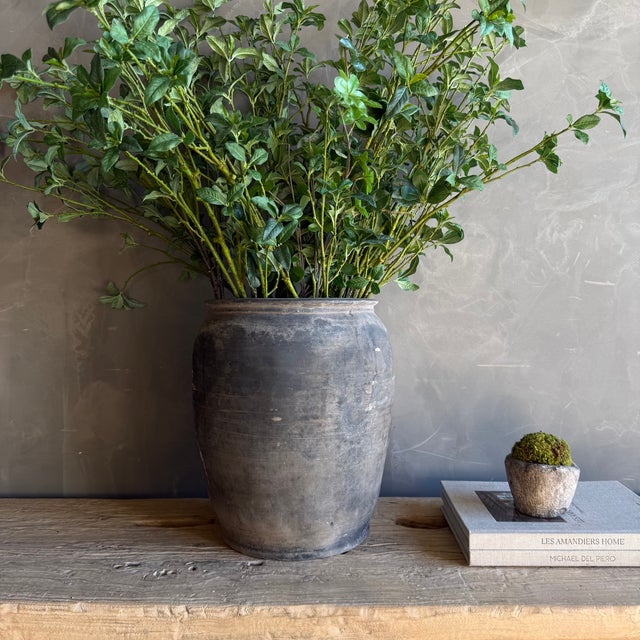 This exquisite vintage clay pottery piece showcases a stunning matte gray finish that beautifully accentuates its unique...