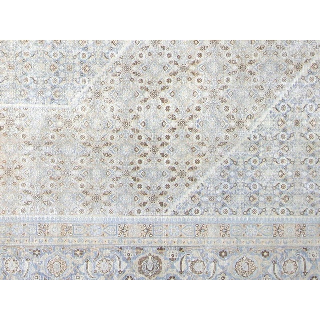 This lavish hand-knotted Persian Tabriz rug adds the perfect touch of elegance to any space. Its intricate design features...