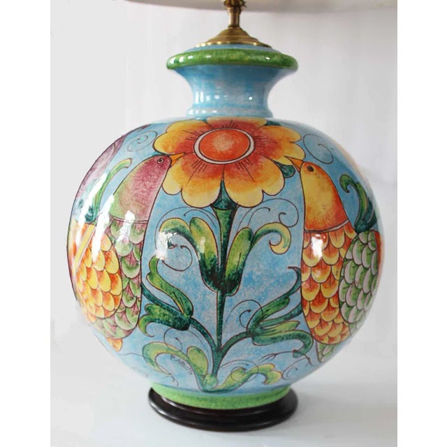 Late 20th century ceramic colorful table lamp with shade. Glazed and painted with birds, flowers and fruit motif. Height...