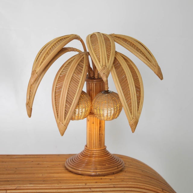 Stunning pair of rattan lamps shaped like coconut palms. Each lamp features six removable fronds (convenient for...