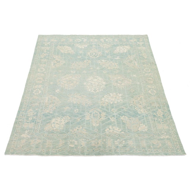 This elegant Modern Oushak Style rug features a refreshing palette of seafoam green and ivory, blending traditional...