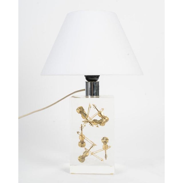 Table lamp in the style of pierre giraudon, 1970s table lamp in resin with inclusions of small gilded violin, circa 1970....
