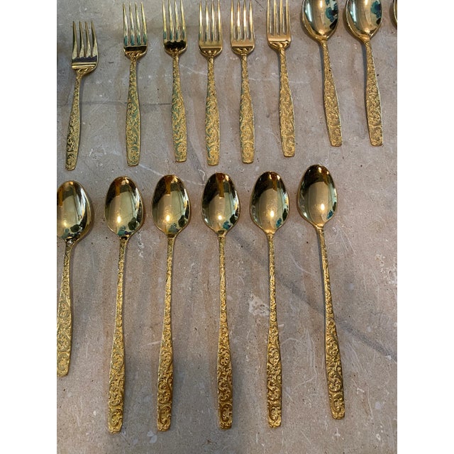 Vintage set of twenty five made in USA vintage 1970s gold pleated flatware set with beautiful botanical motif. Marked...