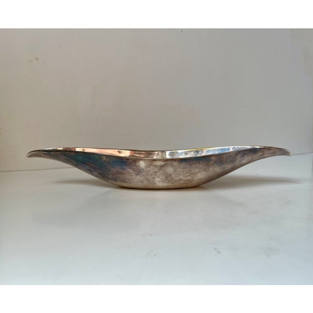 A stylized oblong/banana dish in silver plated brass. Designed by Günter Kupetz in a similar design aesthetics as seen...
