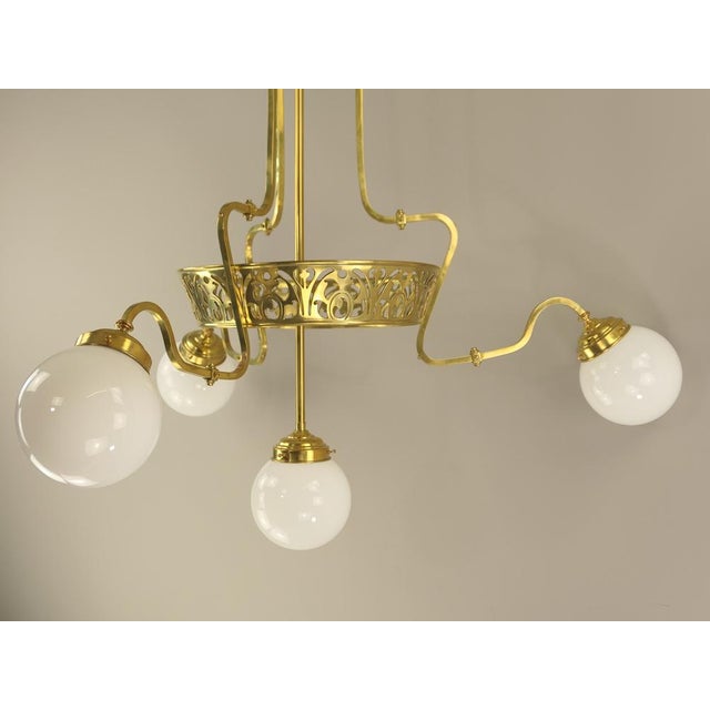 Impressive chandelier - from a bavarian villa - made of massive brass with opal glass shade. the centre and the three...