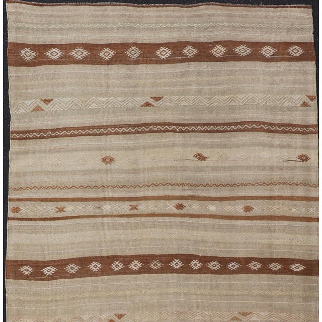Vintage Turkish Kilim Rug With Earthy Tones and Striped Patterns Measures: 4'7 x 9'7 Introduce a touch of heritage and...