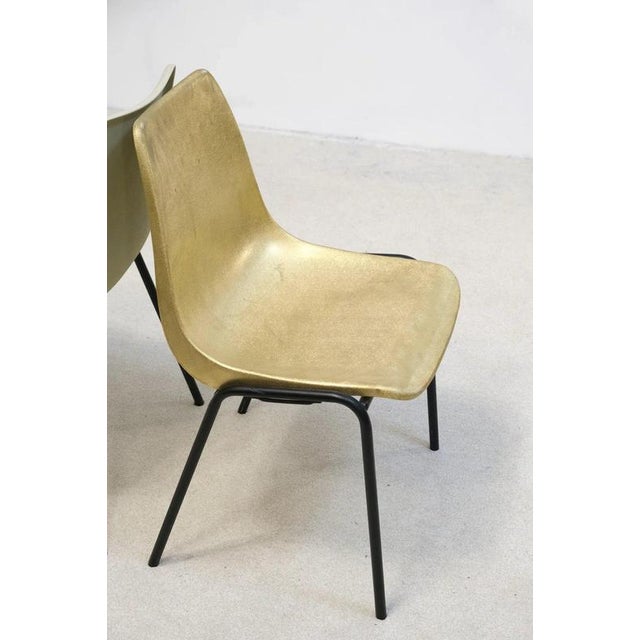 Iconic molded plastic side chairs from German manufacturer Hiller. The chair has been repainted to gold. The structure of...
