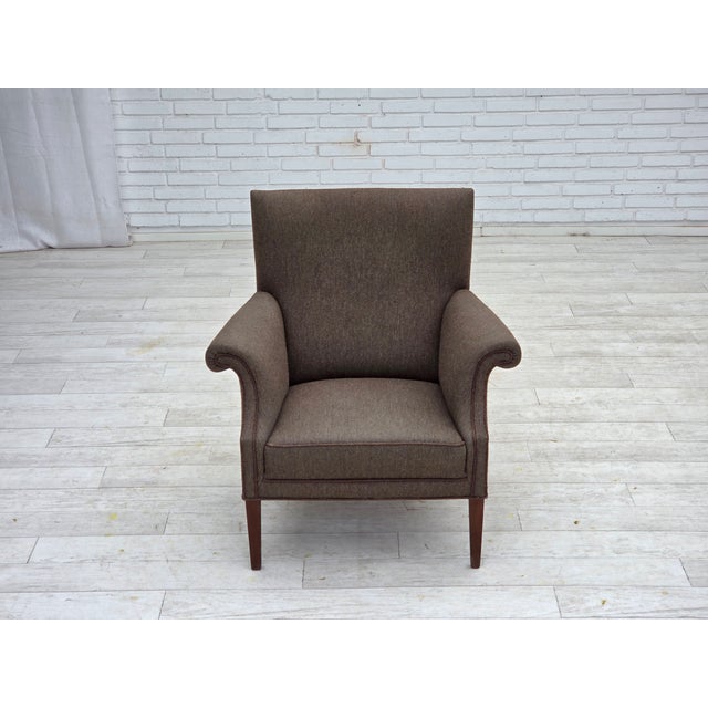 1960s, Danish armchair. Grey furniture wool, ash wood legs, springs in the seat. Chair was reupholstered by craftsman...