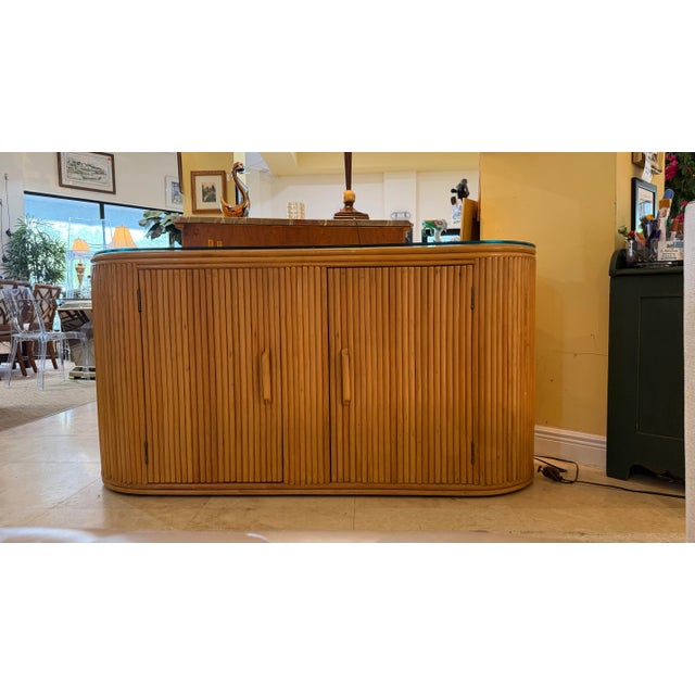 Striking and Sophisticated Mid-Century Modern Pencil Reed Rattan Credenza with Demilune Ends. This handsome sideboard...