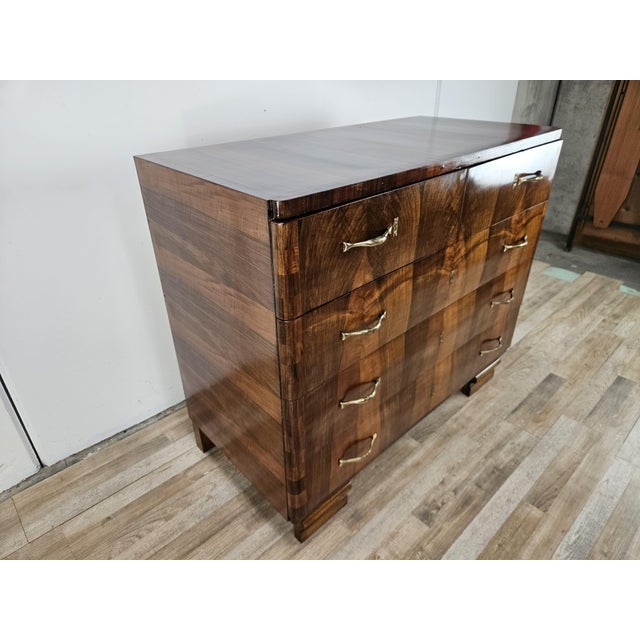 An elegant vintage Art Deco dresser dating back to the 1940s, crafted from walnut burl and featuring a refined grain...