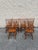 A set of six vintage Windsor-style dining chairs, including four side chairs and two armchairs. Crafted from solid wood,...