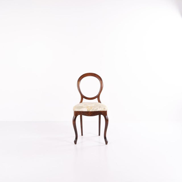 Set of four salon/dining chairs from the 1860s, made of mahogany and upholstered in light floral fabric. Rococo-inspired...