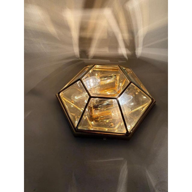 This hexagonal wall or ceiling light is lovingly crafted to bring you joy. The gold plating is so detailed and reflective,...