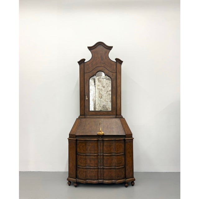 An elegant vintage Georgian-style secretary cabinet crafted in a warm walnut finish with a graceful bonnet crown and...
