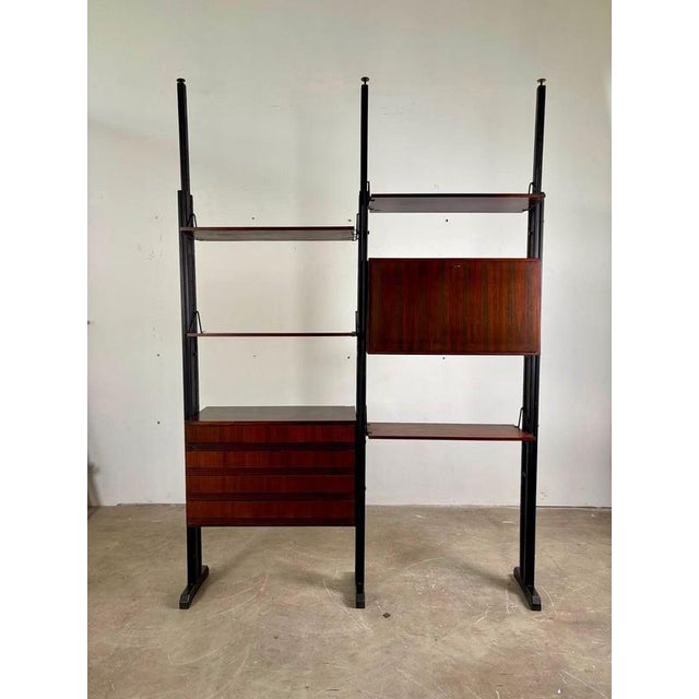 Freestanding modular bookcase, 1960s. A refined example of 20th-century Italian design, featuring a modular floor-to-...