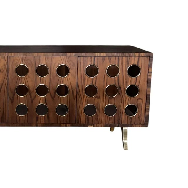 A striking contemporary four-door cabinet crafted in rich dark ebony wood veneer, hand-polished to a soft matte gloss...