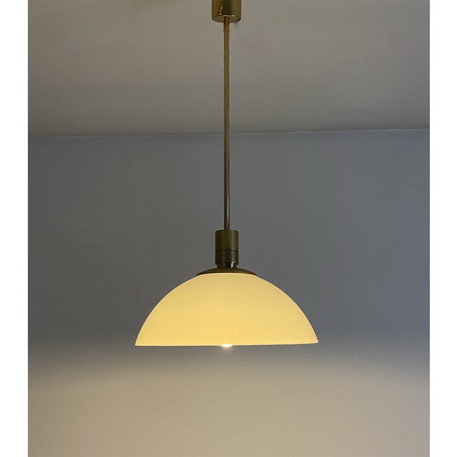 Suspension chandelier with fixed stem made of 24 carat gold-plated metal and lampshade in opal plastic material. This...