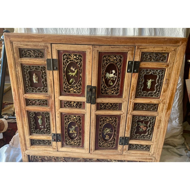 This is a great looking Asian design two door cabinet that would work wonderfully as a sideboard. The front is divided...