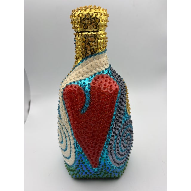 Vintage handmade Haitian voodoo spirit bottle. Gorgeous colors in various patterns that change as you turn the bottle. The...