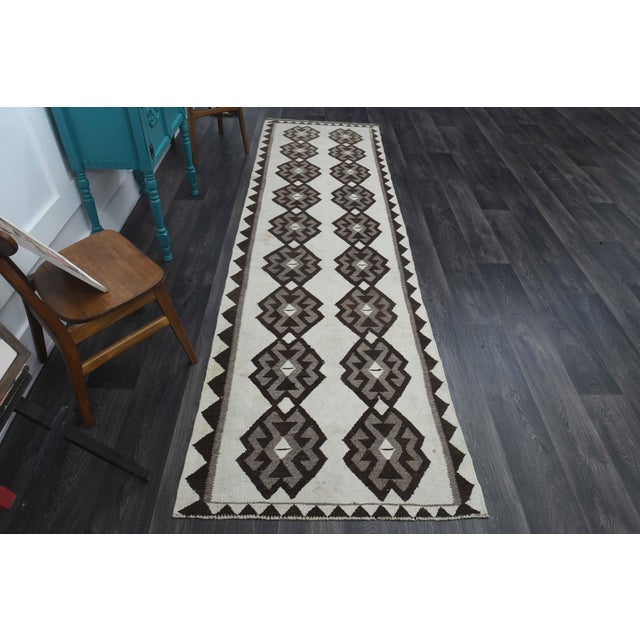 Vintage Hand-Knotted runner rug is a semi-antique vintage runner rug. The '70s Eastern region of Anatolia's unique rug is...