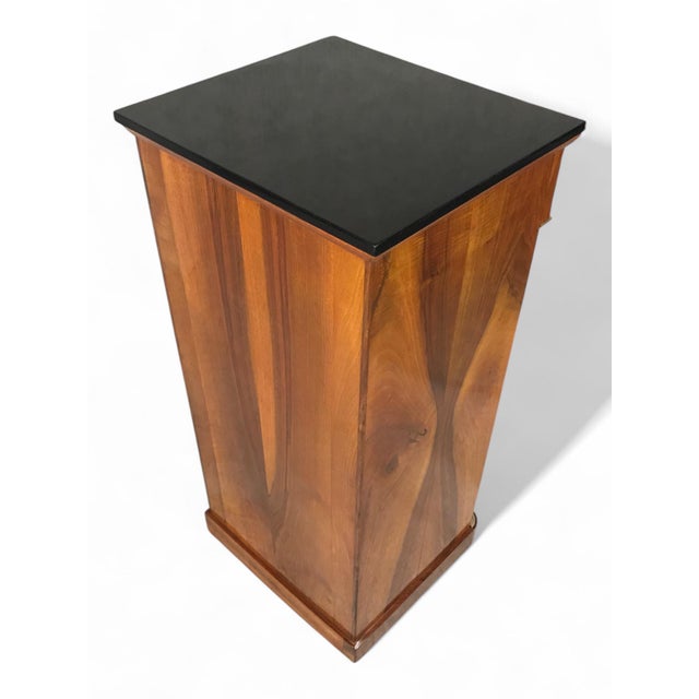 Biedermeier Nightstand in Walnut with Ebonized Top, Germany circa 1830 This refined Biedermeier nightstand from Germany,...
