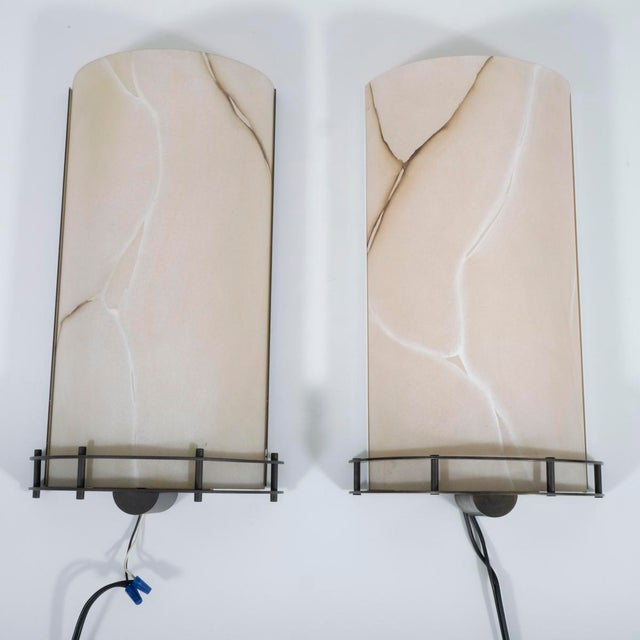 Pair of resin faux marble demilune wall sconces.