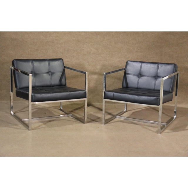 Bring home this gorgeous blend of form and function with two elegant polished chrome and leather lounge chairs. With a...