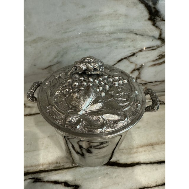 Beautiful, silver plated, antique style with sings of age and use, handled ice bucket with grapes and leaves shaped lid....