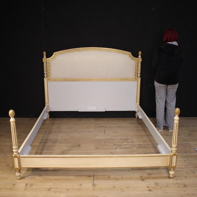 Italian double bed from the mid-20th century. A louis xvi-style furniture made of finely carved, lacquered, and gilded...