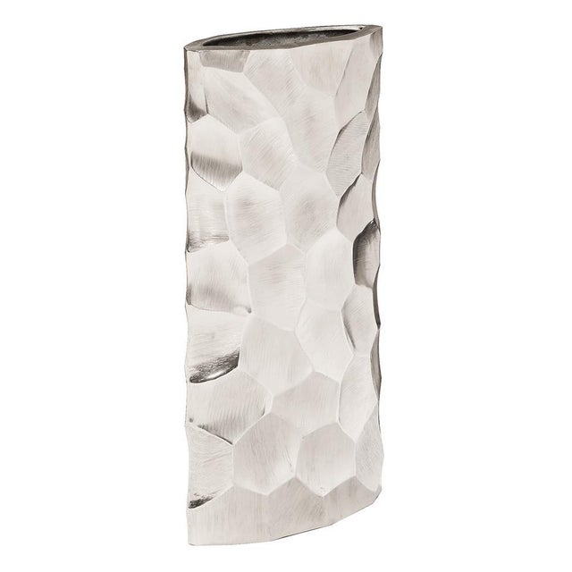 This vase is fashioned from aluminum metal into a tall oval shape. It is characterized by a hammered honeycomb pattern...