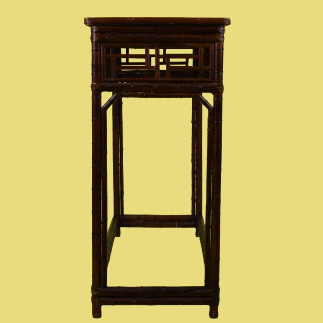 A Ming-style fretwork console with open geometric latticework that keeps the piece airy and light. The classic Asian-...