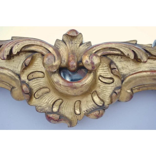 Louis XV style rectangular mirror with glazing bead in carved and gilt wood with swirls, vegetals and acanthus leaves....