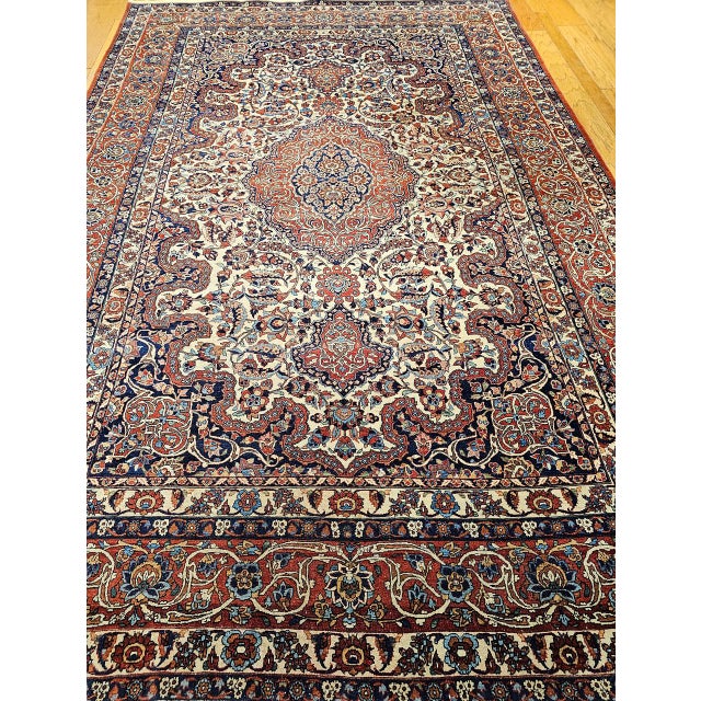 "You will be enchanted in the timeless elegance of this vintage Persian Isfahan room-size rug, dating from the first...