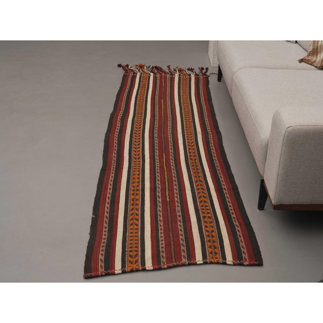 Vintage Hand-Knotted runner rug is a semi-antique vintage area rug. The '70s Eastern region of Anatolia's unique rug is...