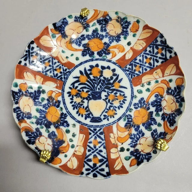 19th C Japanese Imari scalloped edge plate with hanger. Colors are rich and vibrant.