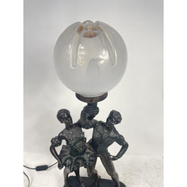 Beautiful 1960s resin lamp depicting a couple of dancers, with a Murano glass bowl. Perfectly working. Excellent...