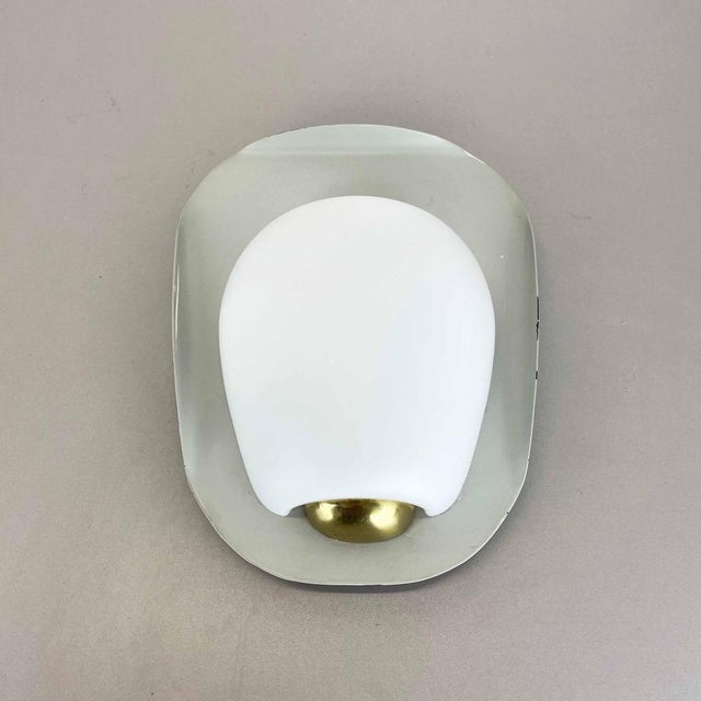 Article: metal and porcelain wall light model "shell" Design: Wilhelm Wagenfeld Producer: Peill and Putzler, Germany AGE:...