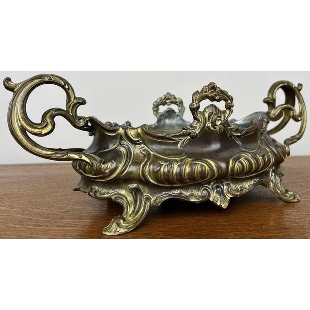 A beautiful vintage French jardiniere, richly decorated with elegant scrollwork and flowing Rococo-style detailing....