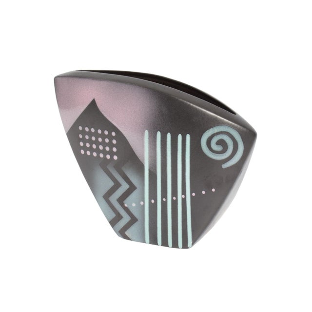 A 1992 Postmodern ceramic vase by John Bergen. This asymmetrical vase is predominantly black with various designs in...