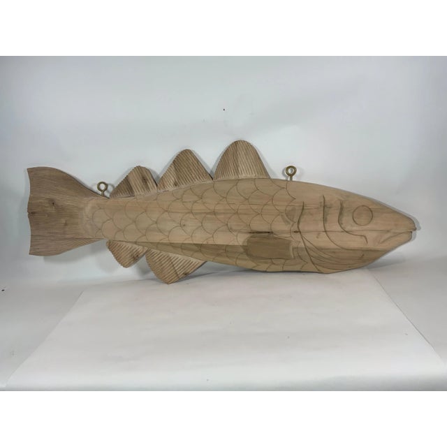 Carved wood codfish trade sign reminiscent of the signs that used to hang in the English fish terminals in the 19th...