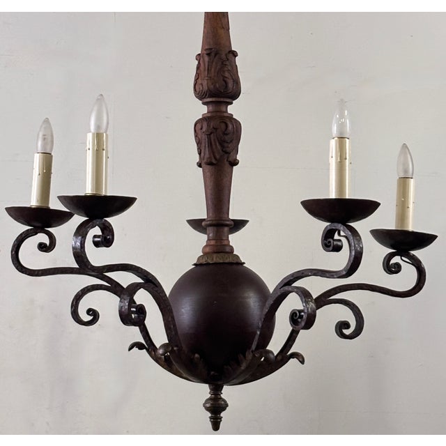 Early 20th century Spanish five arm wrought iron and turned wood light fixture. Mediterranean style blending rustic...