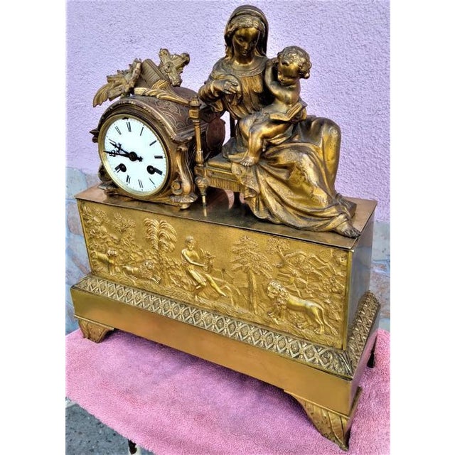 An elegant 19th century French mantel clock crafted in finely cast gilt bronze. The composition features a sculptural...
